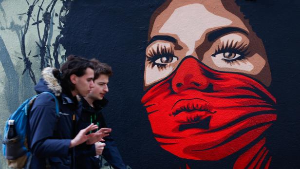 A new mural reminds of the right to protest on the Human Rights Wall in Paris