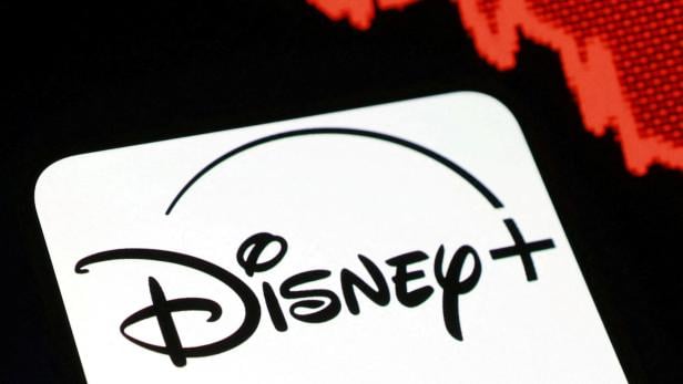 Illustration shows Disney+ logo and decreasing stock graph