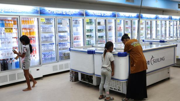 A woman looks at frozen items at the Triple J supermarket in Ebeye