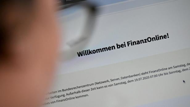 Auf einem Bildschirm steht "Willkommen bei FinanzOnline!".