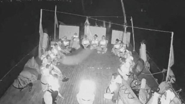 People sit in a circle aboard the Alma, a vessel which is part of of the Global Sumud Flotilla