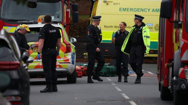 Police officers work at the scene following an incident outside a synagogue, in Manchester