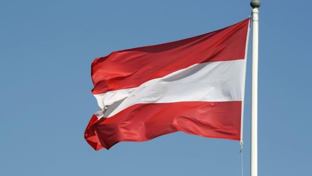 Austrian flag against blue sky, Austria