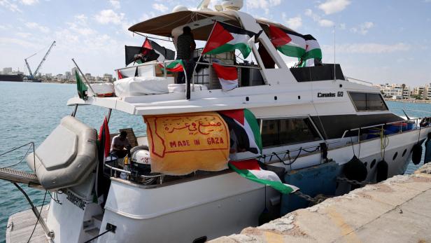 FILE PHOTO: People gather on a boat from a flotilla that had been carrying aid to Gaza until it was intercepted by Israel, docked in the port of Larnac