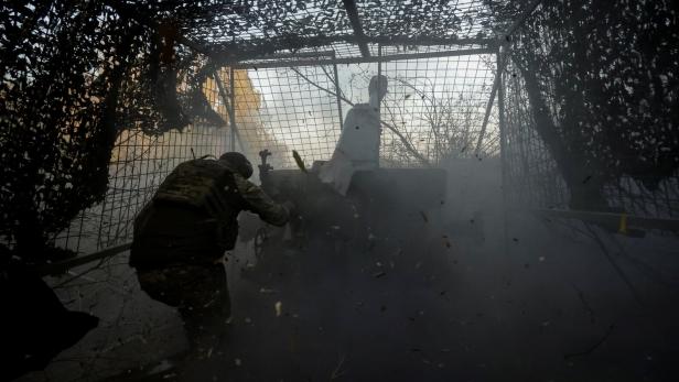 Ukrainian serviceman fires a D-30 howitzer towards Russian troops near the front line town of Kupiansk