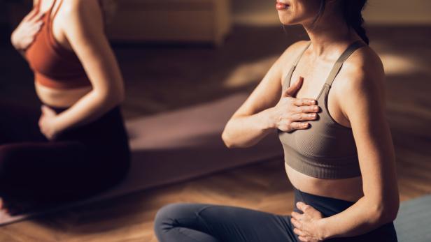 Women Practicing Yoga in a Calm Studio Environment for Wellness