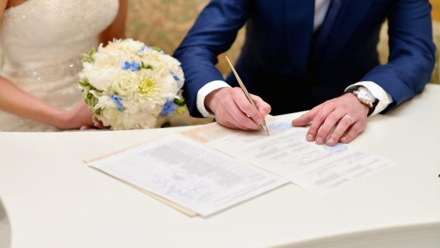 Beauty bride and handsome groom are registering the marriage