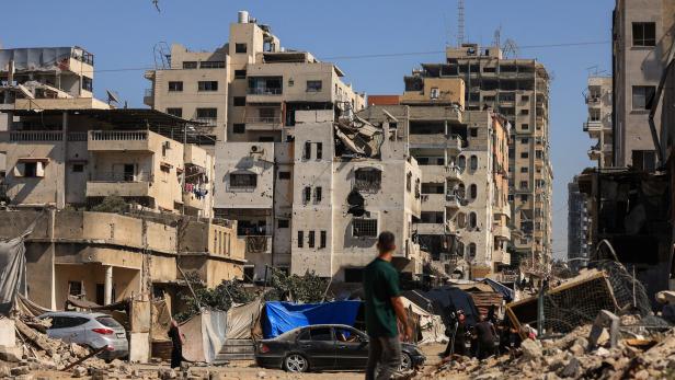 A missile falls towards an evacuated residential building, which was housing displaced people, in Gaza City
