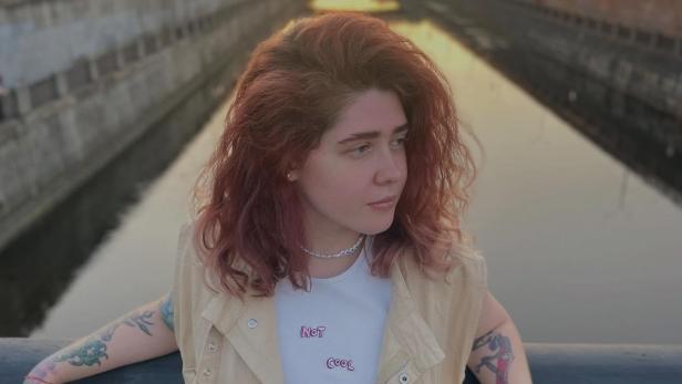 Vera Kravtsova Vera Kravtsova posiert mit roten Haaren an einer Brücke