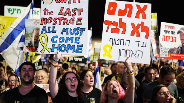 People attend a rally at Hostages Square, in Tel Aviv