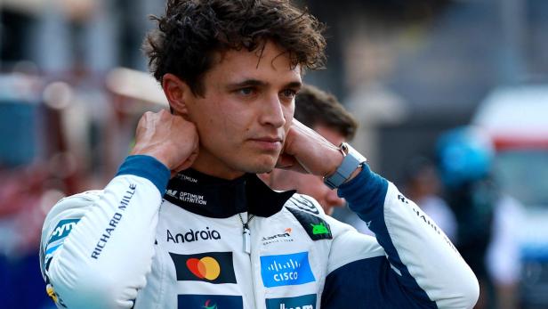 Mexico Grand Prix Lando Norris in Rennkleidung mit Sponsorenlogos blickt nachdenklich zur Seite.