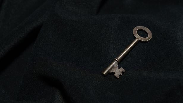 Vintage key on black background