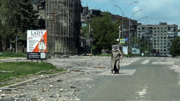 FILE PHOTO: A resident walks at a street near buildings in the frontline town of Pokrovsk