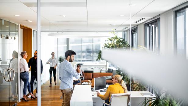 Businessman talking to the receptionist in the lobb