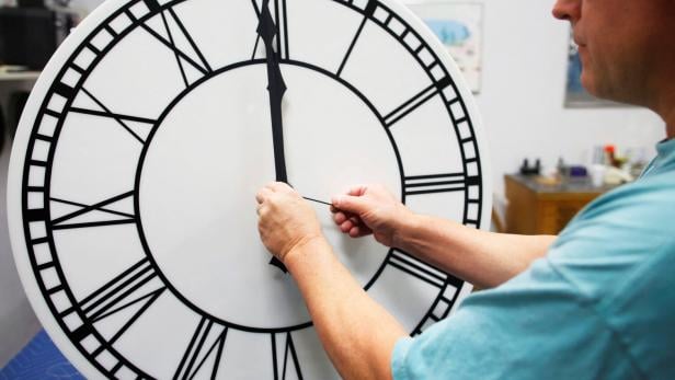 FILE PHOTO: Scott Gow assembles a clock dial at the Electric Time Company in Medfield
