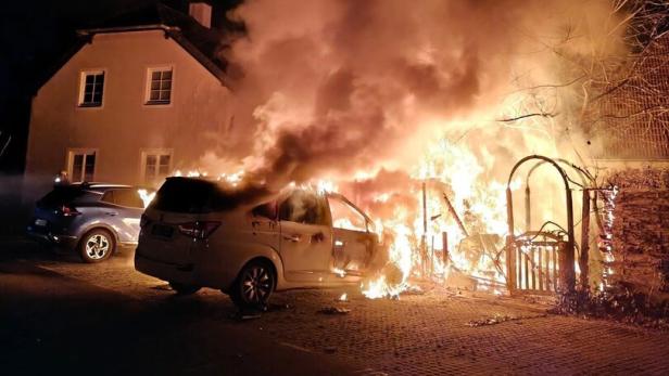 Autos und Hütte in Flammen