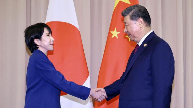 Japanese Prime Minister Sanae Takaichi shakes hands with Chinese President Xi Jinping ahead of their talks in Gyeongju, South Korea