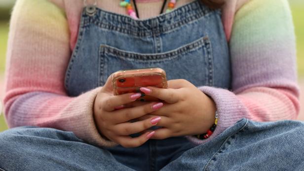 Teens discuss Australia's social media ban for under-16s, set to take effect December 10, in Sydney