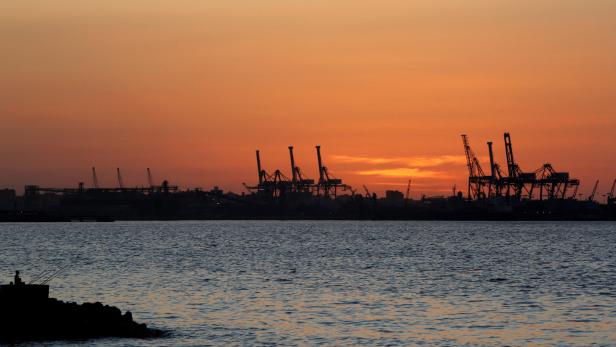 FILE PHOTO: The sun sets over the port of El Dekheila near the fishermen's village of El Max in the Mediterranean city of Alexandria