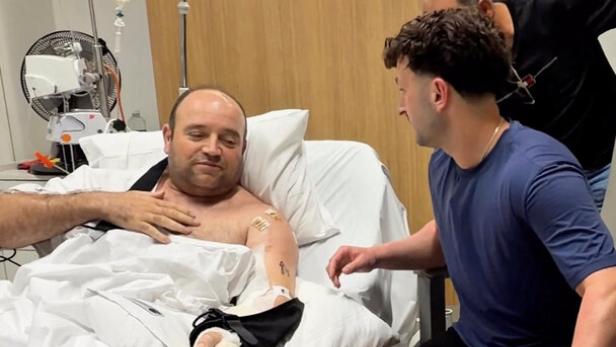 Influencer Zachery Dereniowski gives a donation check to Ahmed Al-Ahmed, the hero at Bondi Shooting