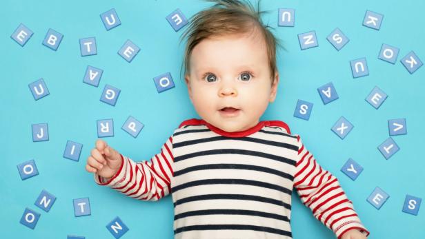 Portrait of adorable 3 months old baby on the blue background, studio shot