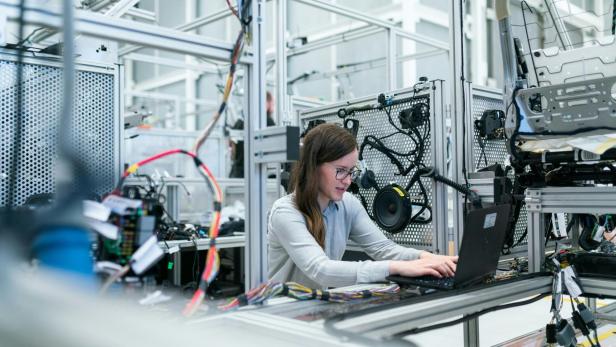 Junge Frau arbeitet im technischen Maschinenbau.