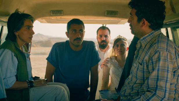 Fünf Menschen in einem Lieferwagen.