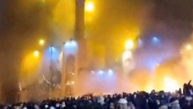Smoke rises from a mosque as protesters gather amid evolving anti-government unrest Tehran