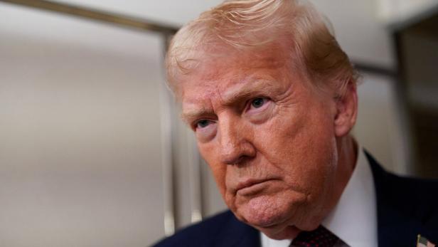 U.S. President Donald Trump looks on as he meets with members of the media aboard Air Force One en route from Florida to Washington