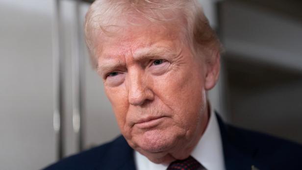U.S. President Donald Trump speaks with members of the media aboard Air Force One en route to Joint Base Andrews