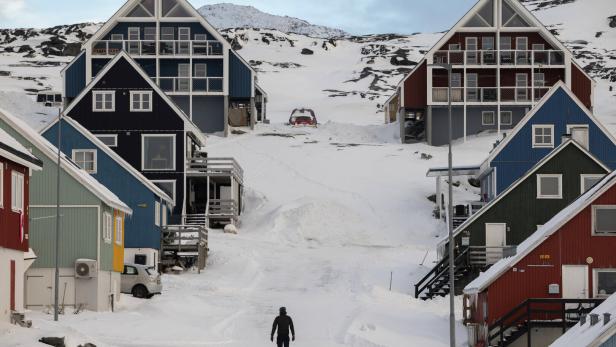 A man stands on a street on the day of the meeting between top U.S. officials and the foreign ministers of Denmark and Greenland, in Nuuk