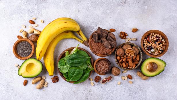 Lebensmittel, die viel Magnesium enthalten, wie Samen und Nüsse und Blattspinat.