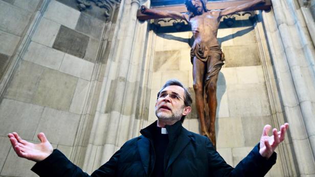 Ein Priester, es ist Wiens neuer Erzbischof Grünwidl, steht in einer Kapelle vor einem Kreuz.