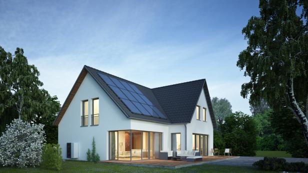 Modern house in the evening with electric heat pump