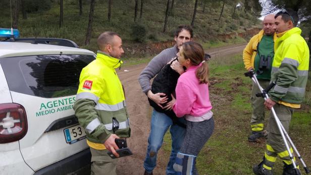Ana Garcia Aranda hugs her dog 'Boro' after it was rescued by Andalusia regional firefighters days after the deadly derailment of two high-speed trains, in Adamuz