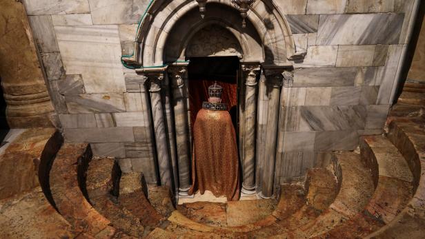 Worshipers pray inside the Church of Nativity, in Bethlehem