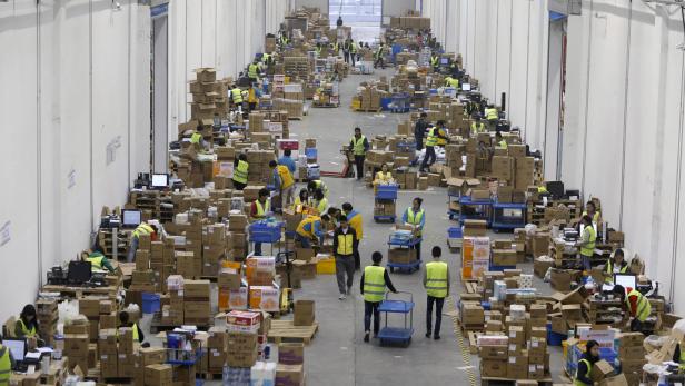 Employees sort boxes and parcels at the logistics centre of a express delivery company, after the Singles Day online shopping festival, in Wuhan