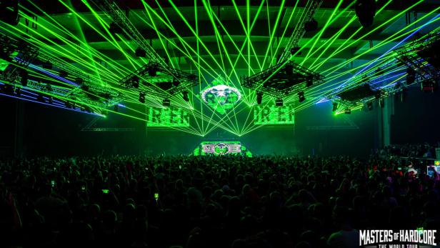 Grüne Laserstrahlen und eine große Menschenmenge vor der Bühne prägen die energiegeladene Atmosphäre beim Masters of Hardcore Festival im VAZ St. Pölten.