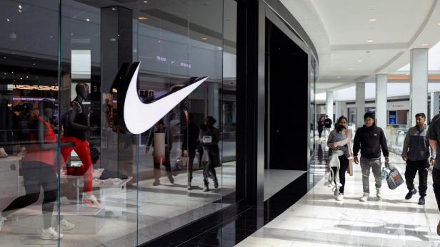 FILE PHOTO: Shoppers walk past a Nike store in the King of Prussia Mall, in King of Prussia, Pennsylvania