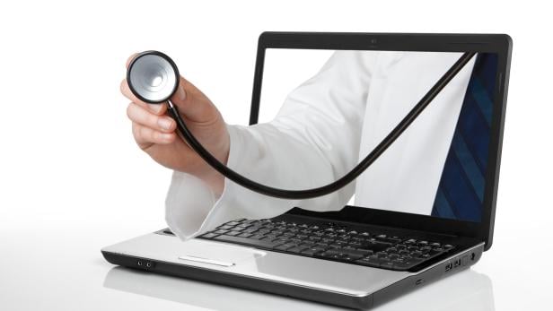 Ein Stethoskop kommt aus einem Laptop-Bildschirm.