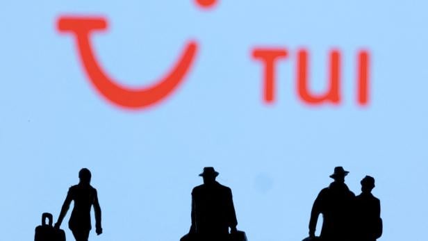 FILE PHOTO: Figurines are seen in front of Tui logo