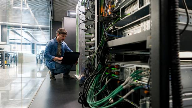 Computer technician fixing a network server at the office