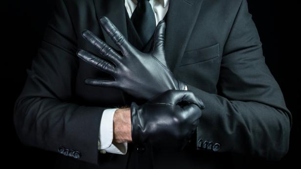 Mafia Hit Man Pulling on Leather Gloves