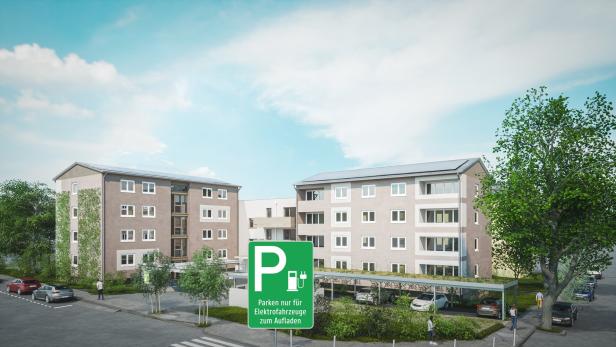 Zwei Gebäude, davor eine Parkplatz-Tafel