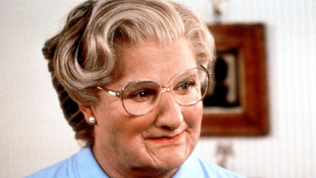 Robin Williams als Mrs. Doubtfire mit Brille und hellblauer Bluse.
