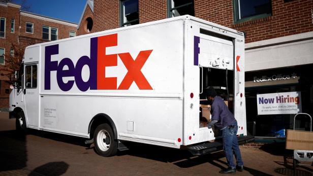 FILE PHOTO: A driver of FedEx loads packages into a delivery truck during Black Friday preparations in the Georgetown neighborhood of Washington