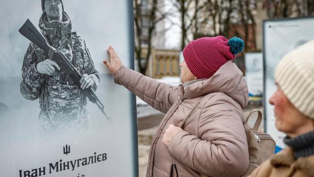 People gather to mark the fourth anniversary of the full-scale Russian invasion of Ukraine, in Irpin