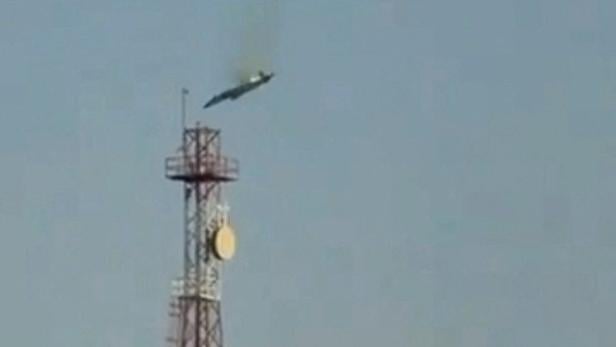 A burning aircraft falls from the sky in Al Jahra, in this still image obtained from social media video