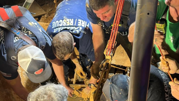 Einsatzkräfte der Feuerwehr Palatka befreien Andrew Giddens mit Seilen und Ausrüstung aus dem schlammigen Boden der Kiesgrube.