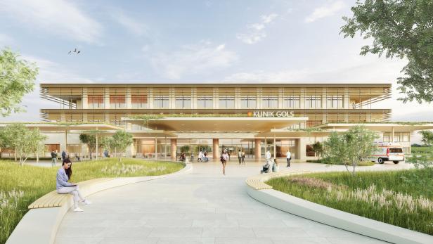 Modernes Klinikgebäude mit großen Glasfronten, umgeben von Grünflächen, Menschen sitzen und gehen auf dem Vorplatz.